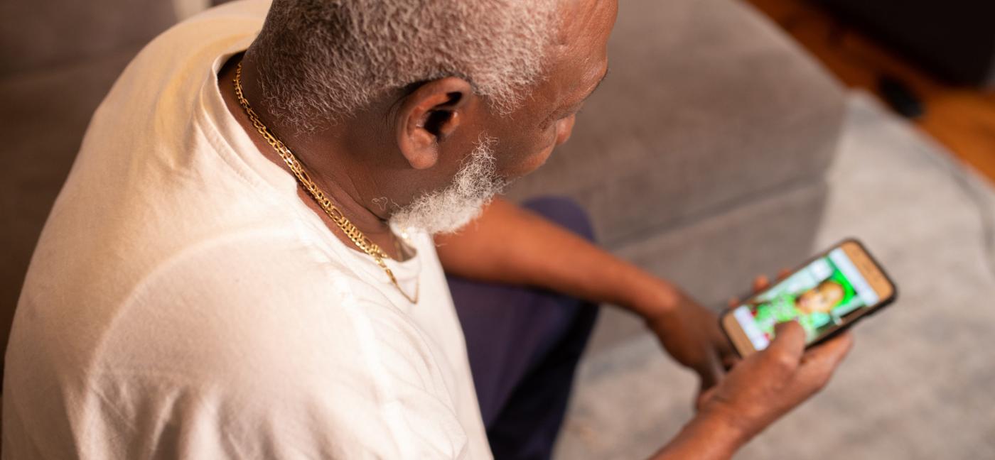 Older man looking at mobile phone screen