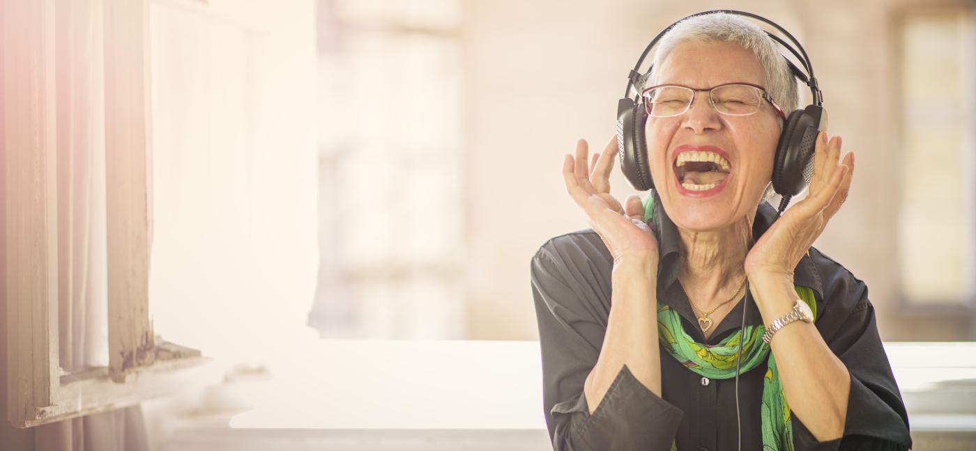 Older woman listening to music on headphones