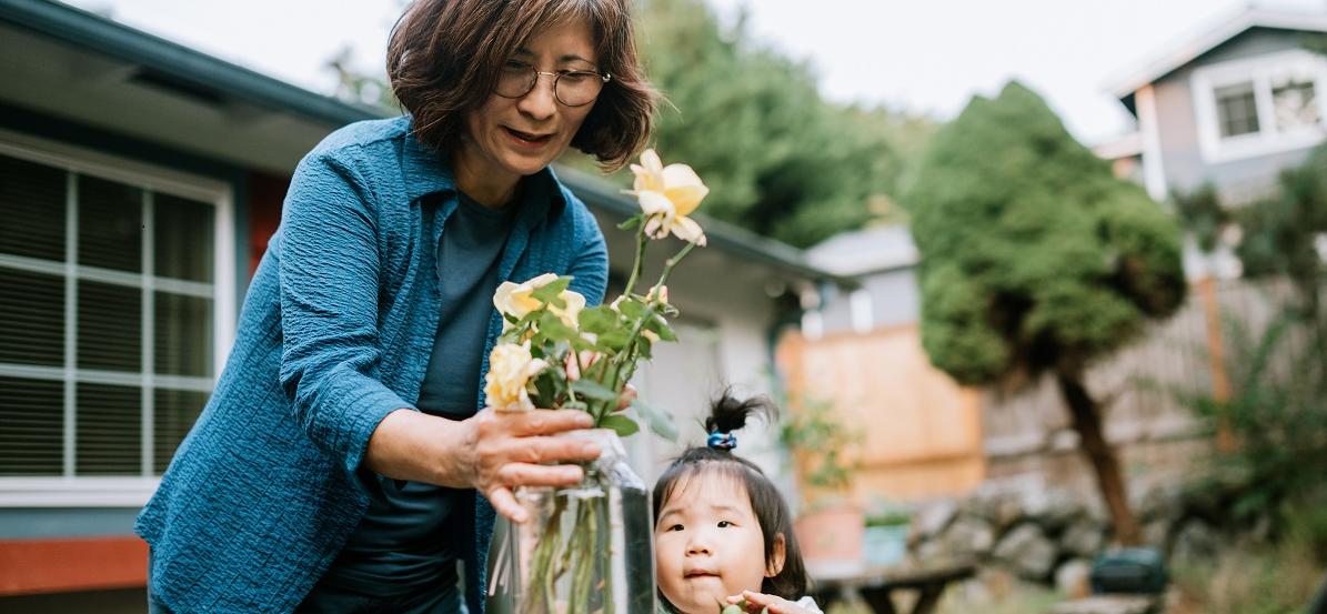 Grandmother Puts Flower in Vase