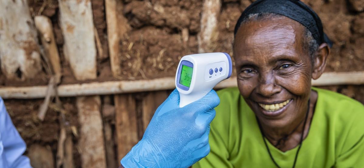 older woman with doctors hand