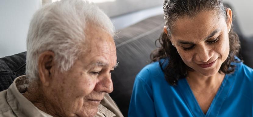 nurse and older adult using tablet