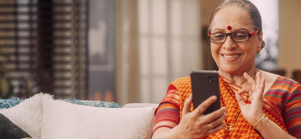 indian woman with a smartphone smiling