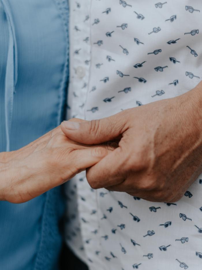 Older couple holding hands