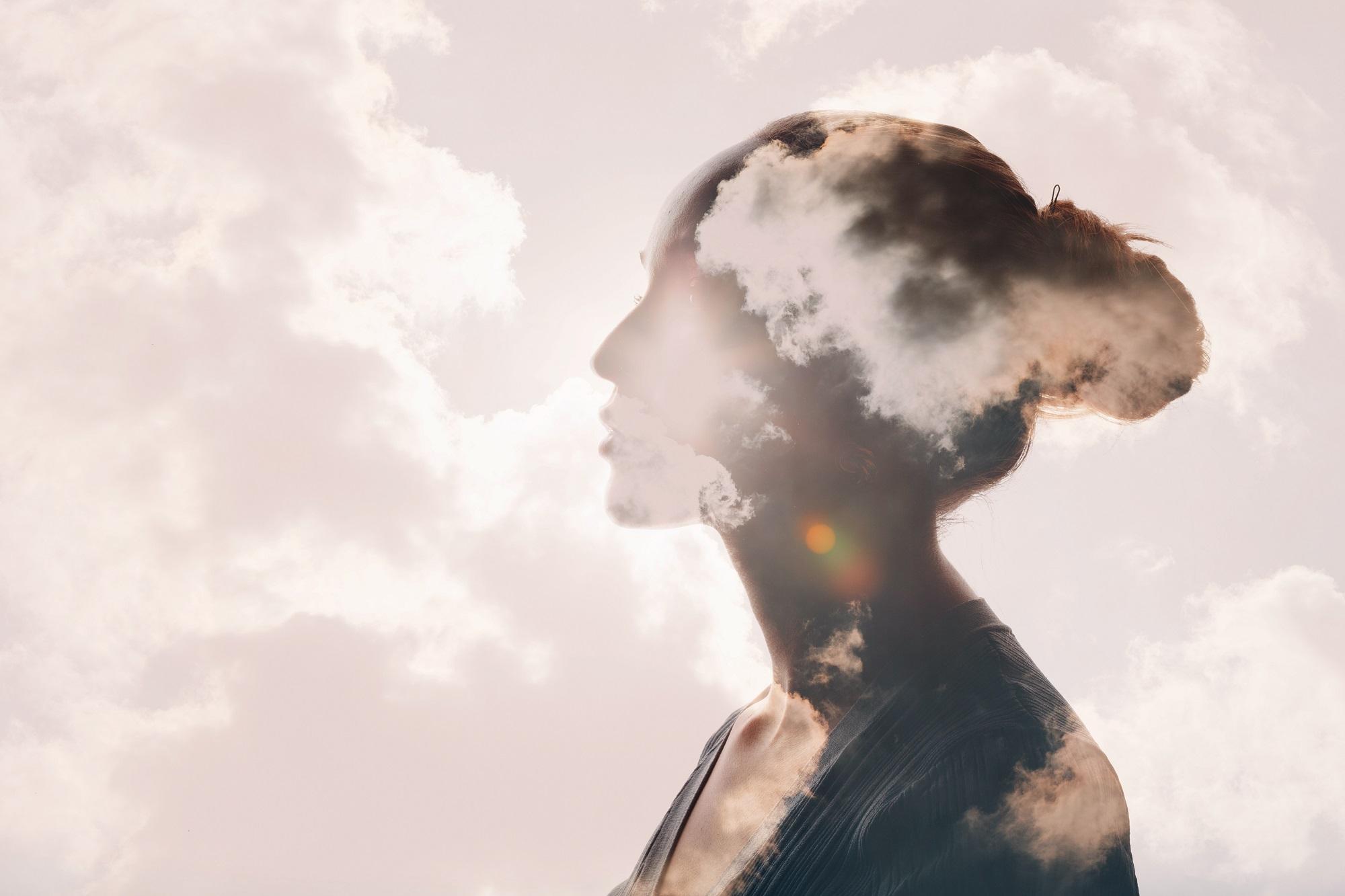 silhouette of young woman with clouds