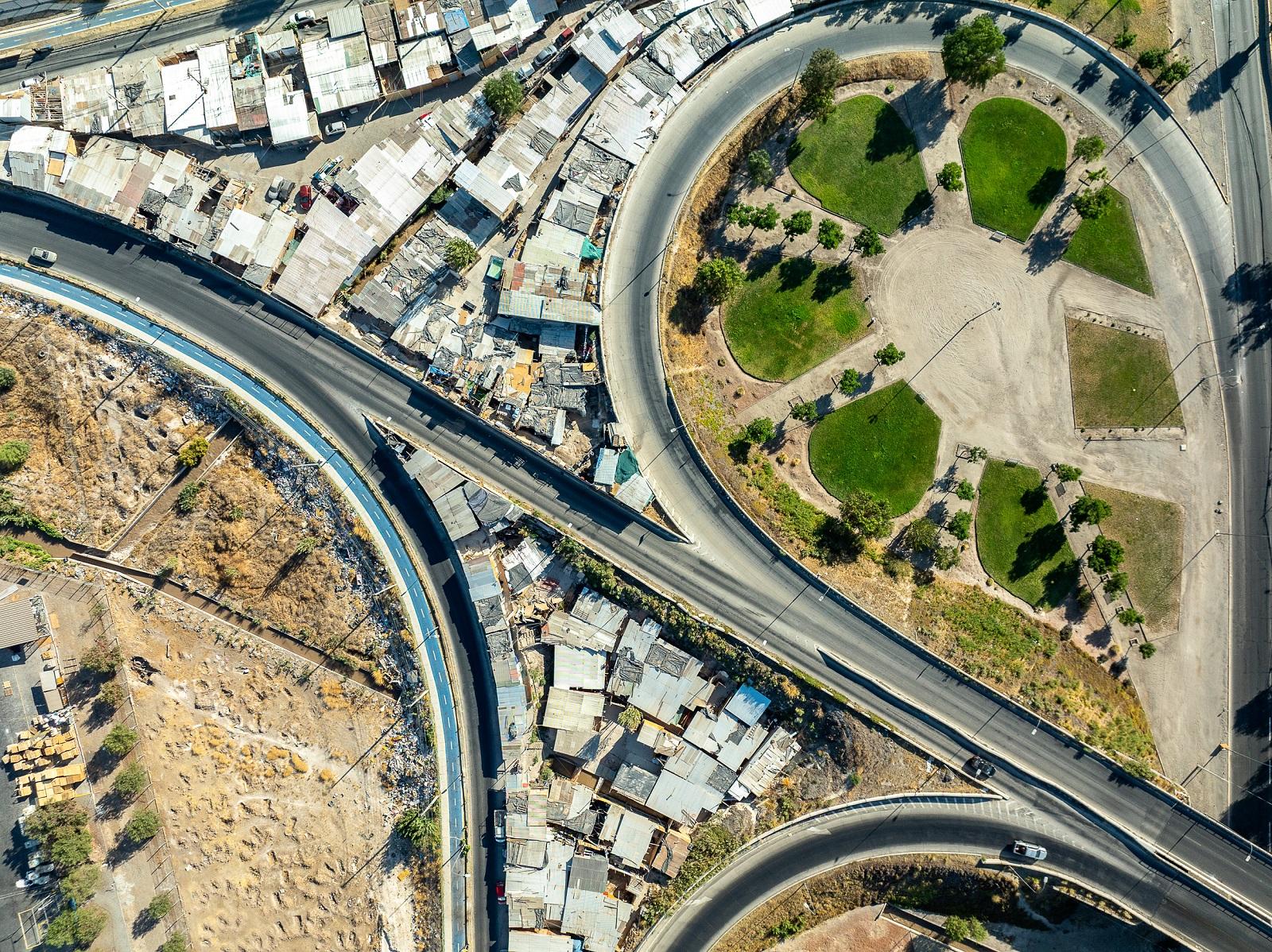 Unequal Scenes Chile Houses are squeezed into the limited space available on the side of a highway in Maipú.