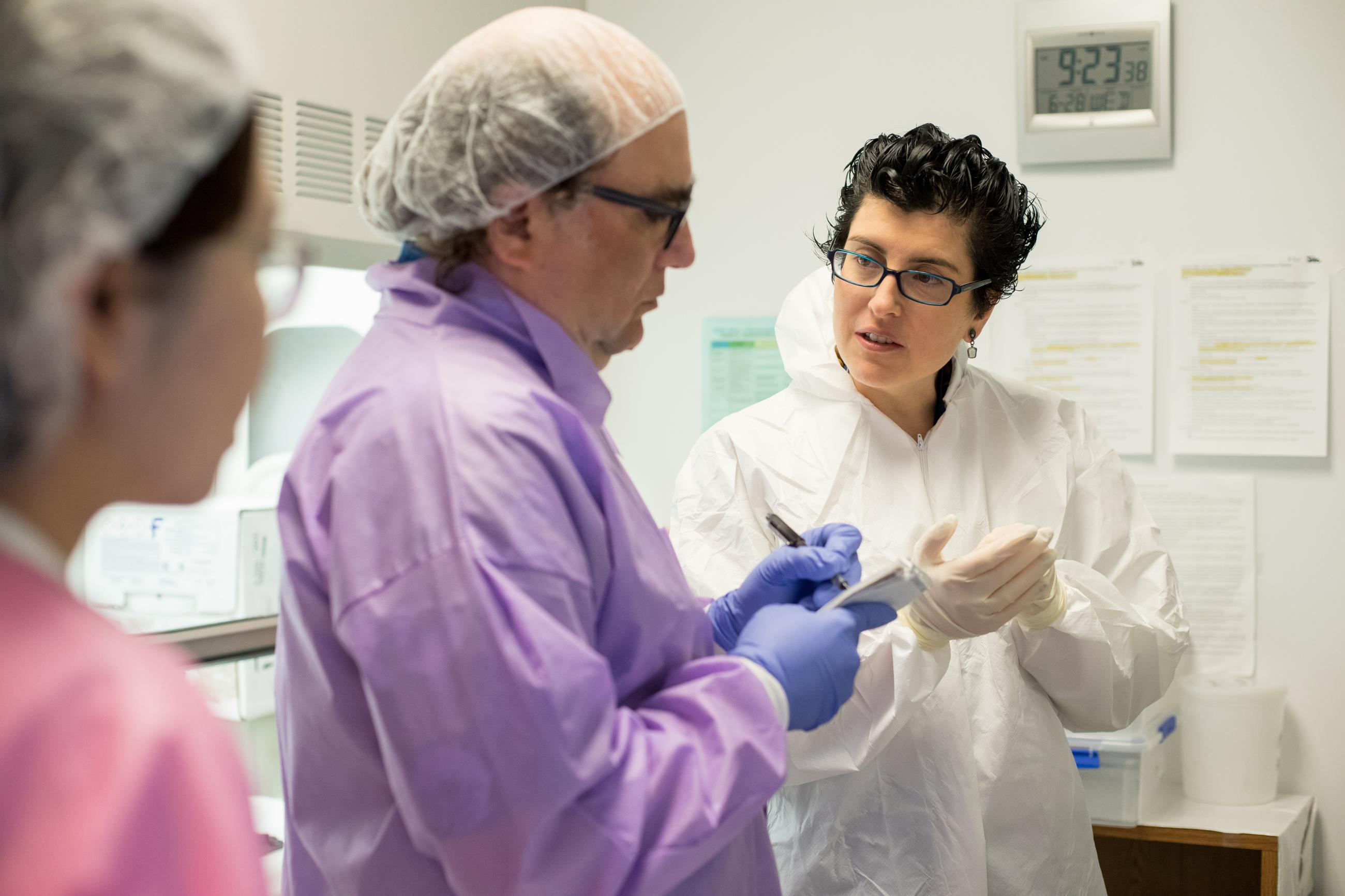 Lea Grinberg and colleagues review notes during a clinicopathological session at the Sandler Neurosciences Center.