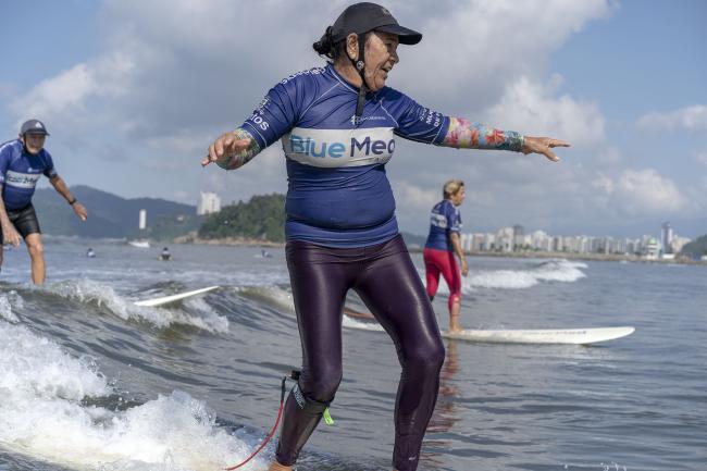 Older person surfing in Brazil - photo by Alex Kornhuber