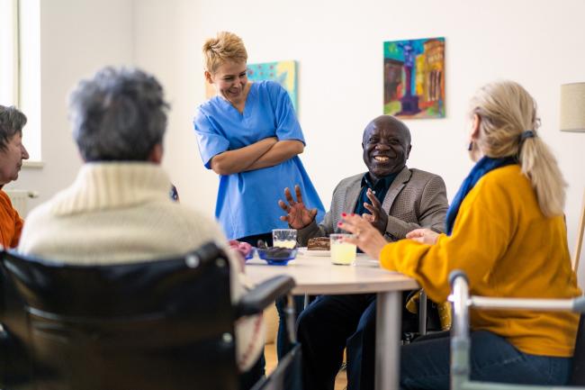 group of people of mixed ages talking in a circle