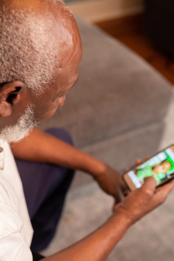 Older man looking at mobile phone screen