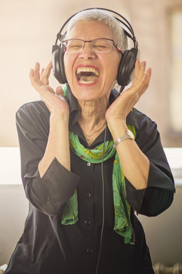 Older woman listening to music on headphones