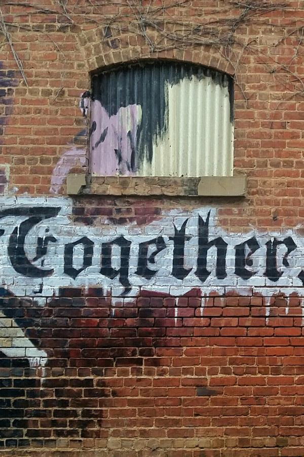 Graffiti mural with the words, &quot;togeter, we create!&quot;