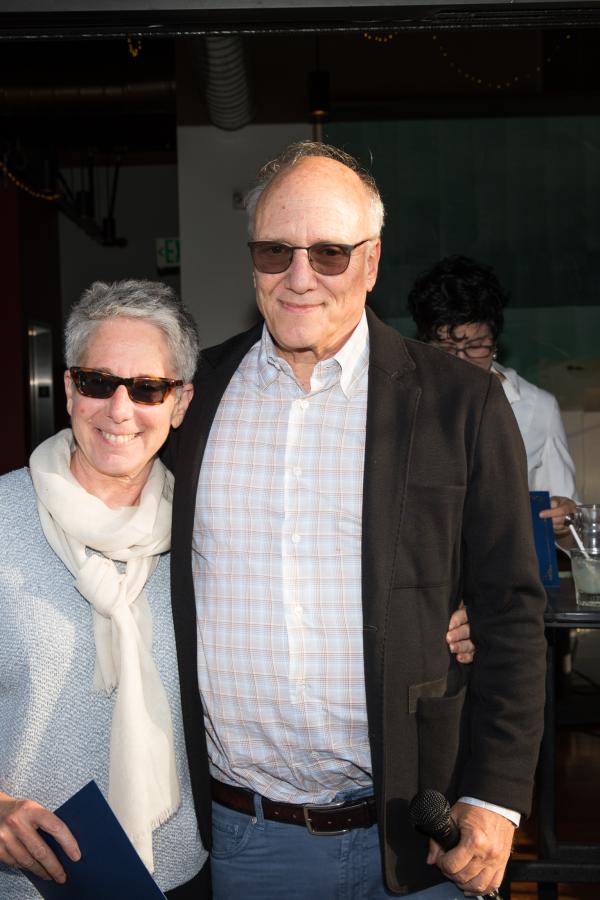 Bruce Miller and Cindy Weinstein stand with each other look at camera