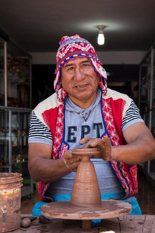 Older adult Peru making pottery