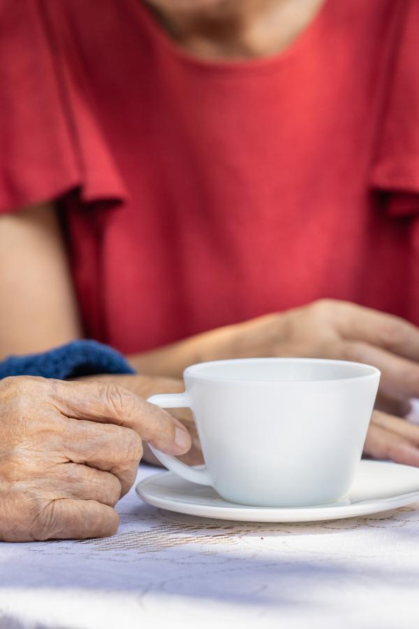 Senior woman relaxing with daughter in backyard