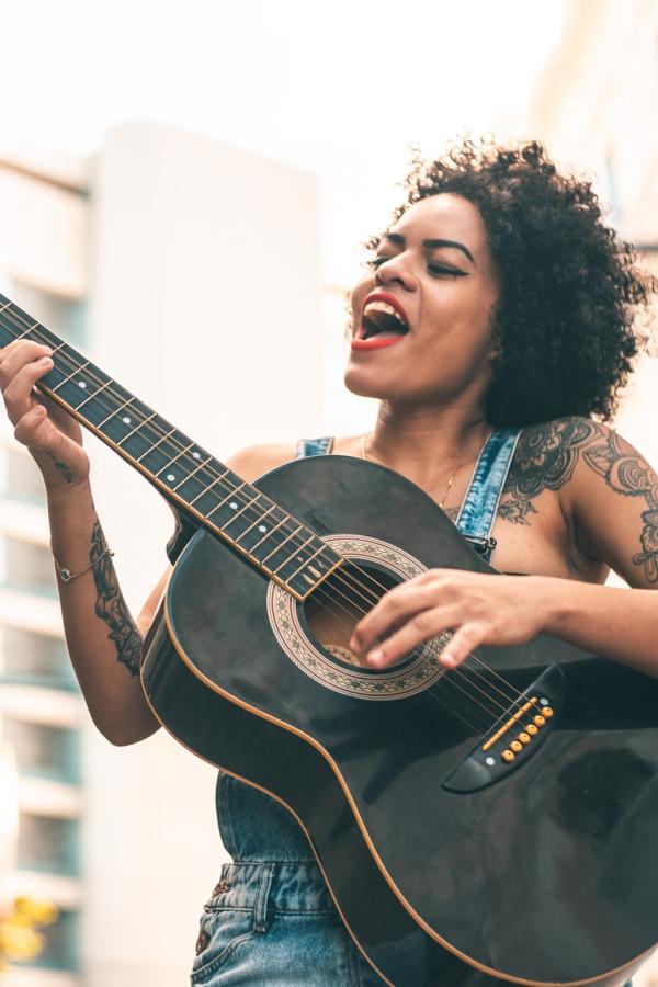 younger woman with guitar