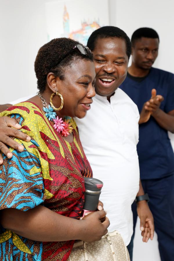 Kunle Adewale and a guest at art exhibit