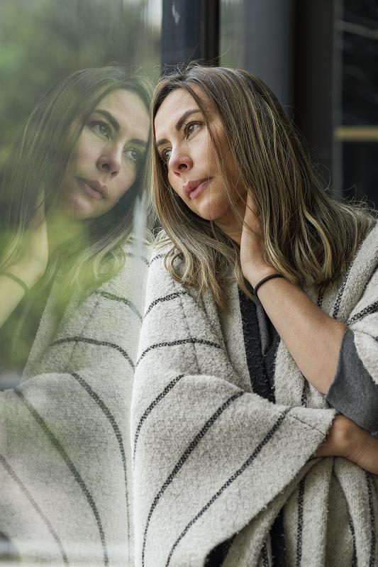 Colombian woman leaning on the window