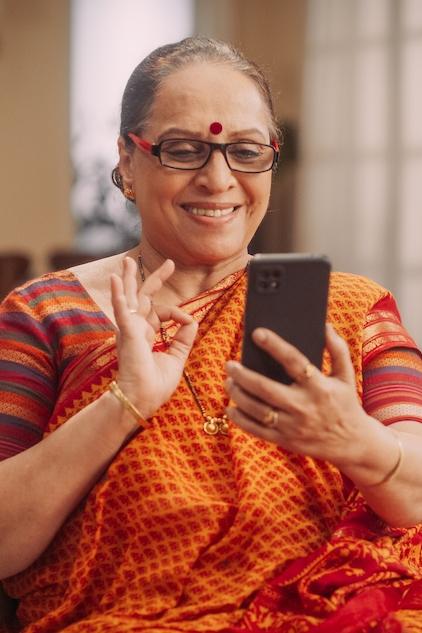 indian woman with a smartphone smiling