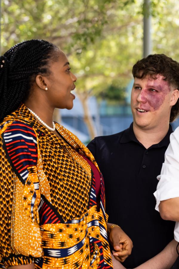 Five Atlantic Fellows for Equity in Brain Health engage in conversation outdoors during a fellowship gathering at UCSF, reflecting the program's collaborative and interdisciplinary learning community.