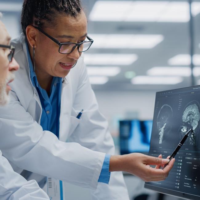 neurologist and neurosurgeon with brain scan