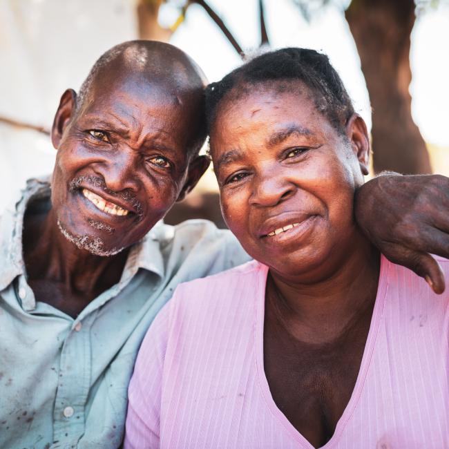 Africa, Older Adult Couple, Content - a Farmer and his wife smiling at the camera for a portrait