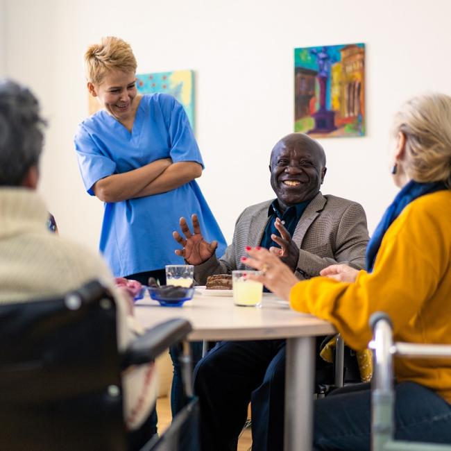 group of people of mixed ages talking in a circle