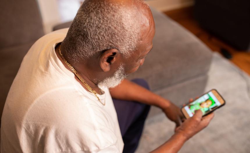Older man looking at mobile phone screen