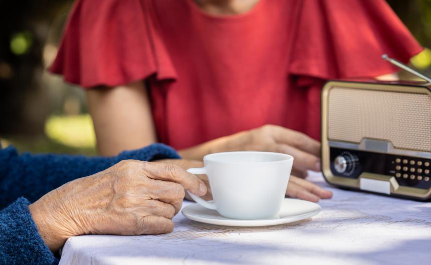 Senior woman relaxing with daughter in backyard