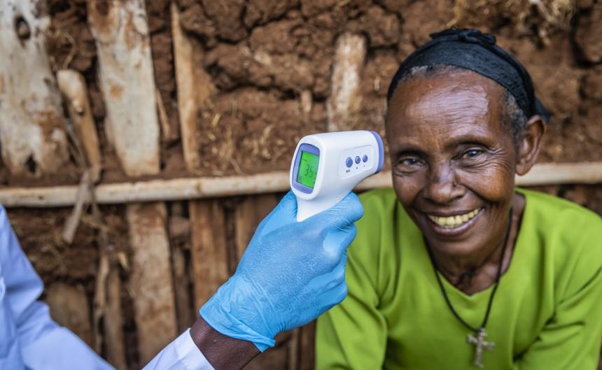 older woman with doctors hand