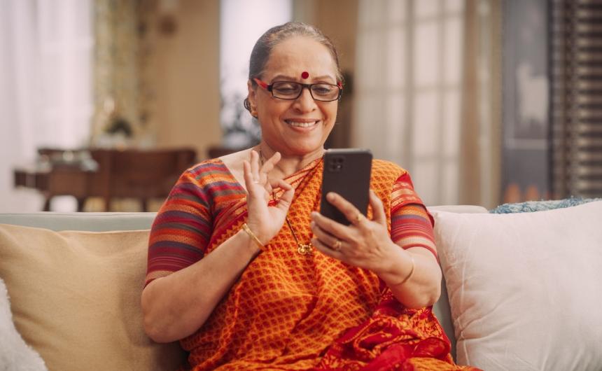 indian woman with a smartphone smiling