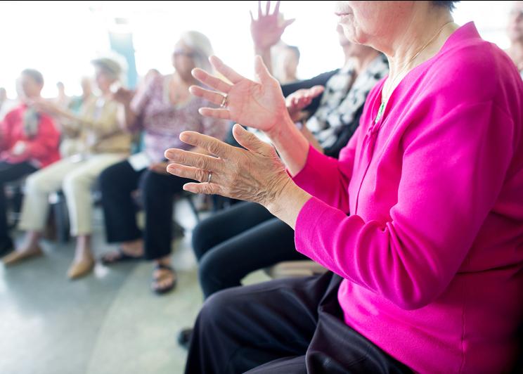 Group of older people clapping