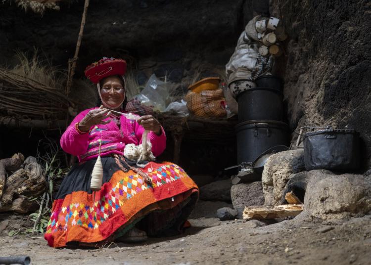 Concepcion Usca Foco, age 67, spins wool on a spindle in her home in the Huilloc Alto community