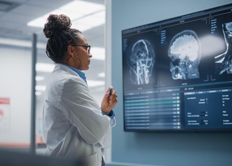 medic reviews MRI scan with brain images