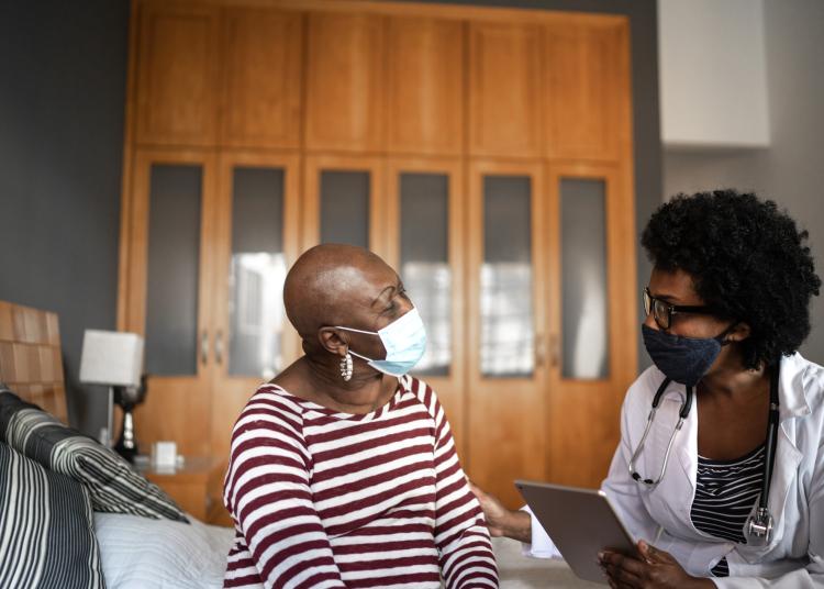 Health visitor and a senior woman during nursing home visit