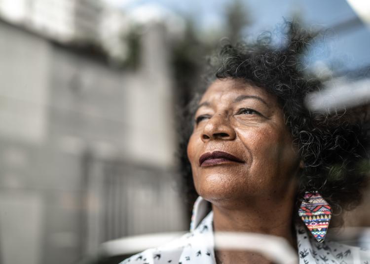 pensive woman looking out window