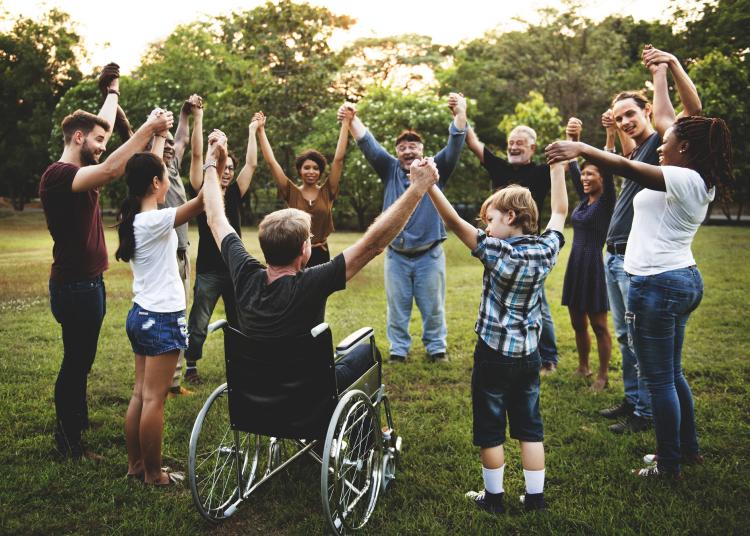 group of people in a park holding hands