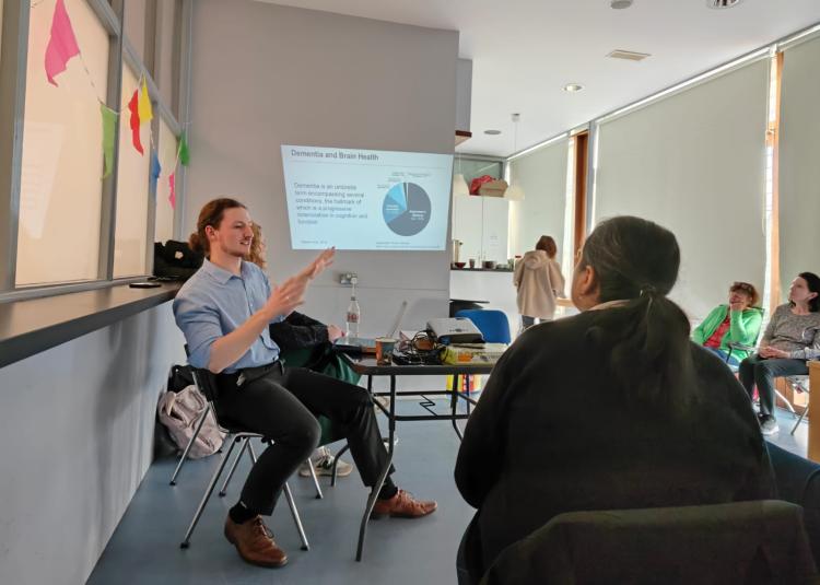 Speaker and guests at outreach event