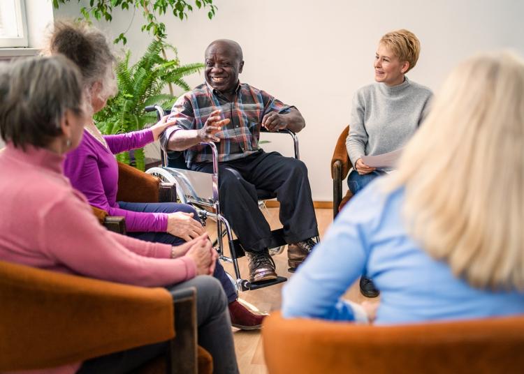 group of people sitting in circle talking