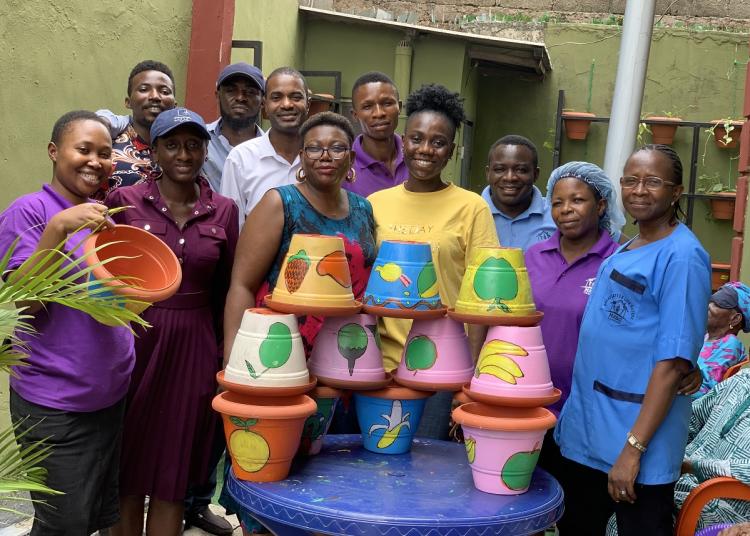 Bloom garden flowerpots and people