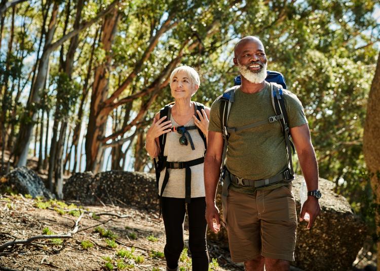 Older adult couple hiking in the mountains