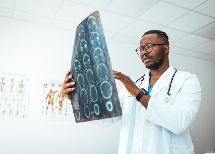 MRI digital x-ray of brain with radiologist doctor oncology working in clinic hospital. Medical healthcare concept. Medical experts studies the EEG condition of the patient. Doctors Examining X-Ray