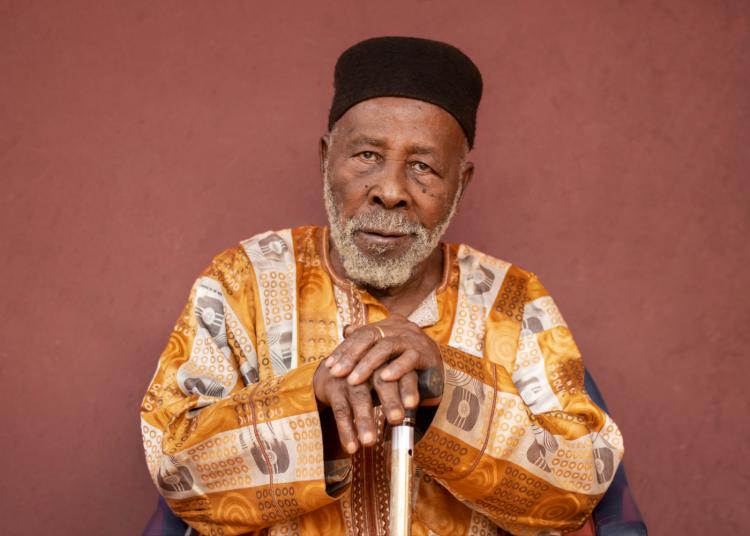 Medium shot old African man exterior portrait