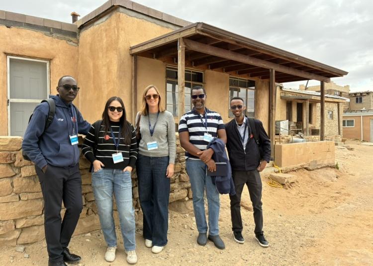 Abel, Stacey, Virginia, Paul and Abera stand together outside an adobe building during a site visit in New Mexico.