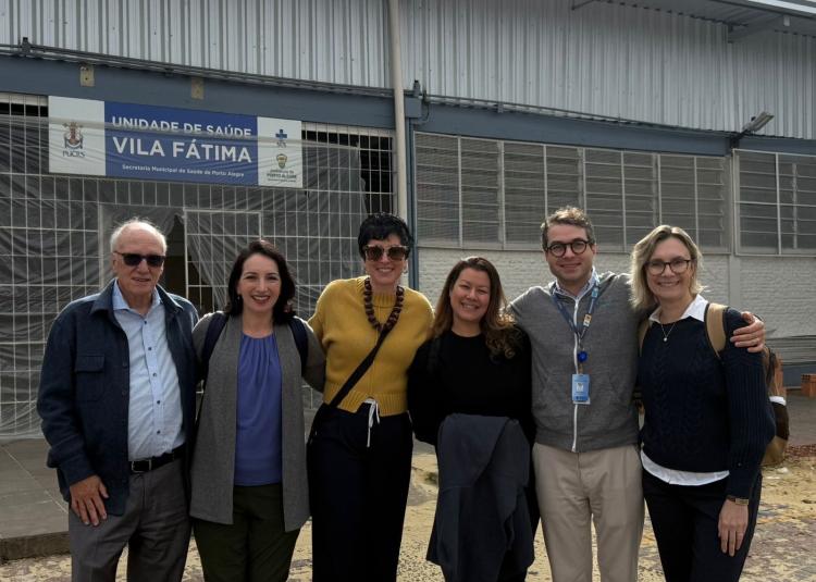 GBHI leaders and Atlantic Fellows stand together outside the Vila Fátima University Extension Center in Porto Alegre.