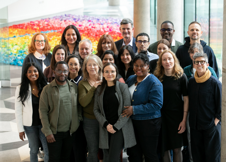 Group of fellows at Creative Brain Week 2025 with a colourful background