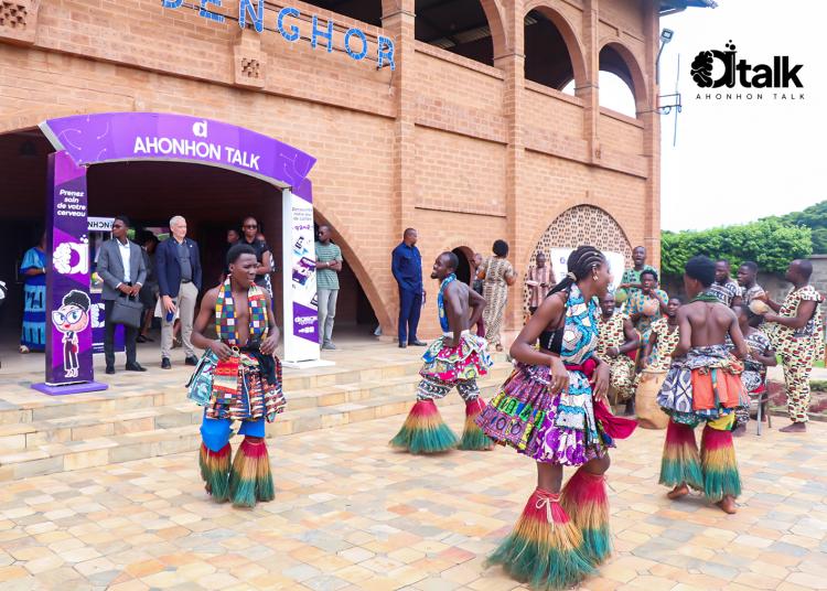 Dancers in colorful traditional clothing perform outside the Agora Senghor entrance during Ahonhon Talk.